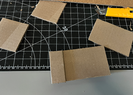 First I measured the size of my phone and took into account which parts would need extra space and cut them out on the cardboard.